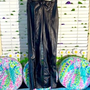 Black vegan leather look polyurethane pants with open vents on the front leg hem